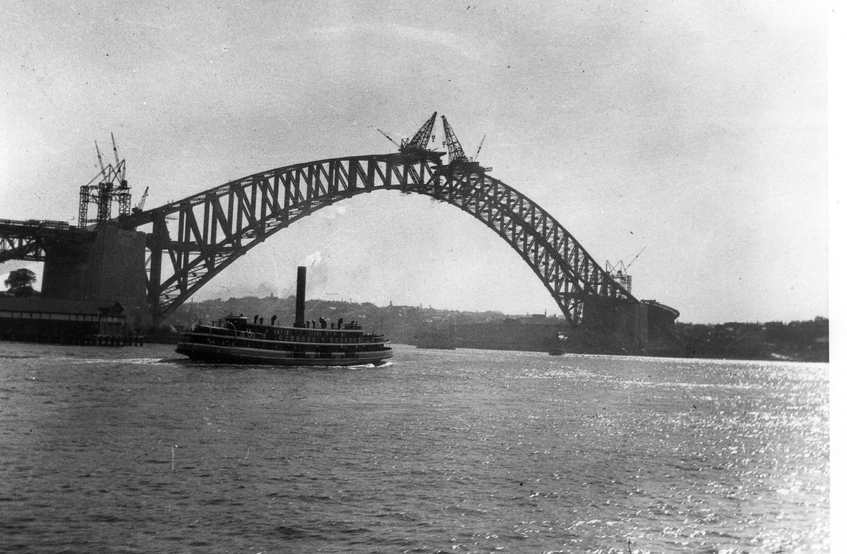 Sydney ferry KUTTABUL in Sydney Cove with Sydney Harbour Bridge under construction 1931, Circular Quay