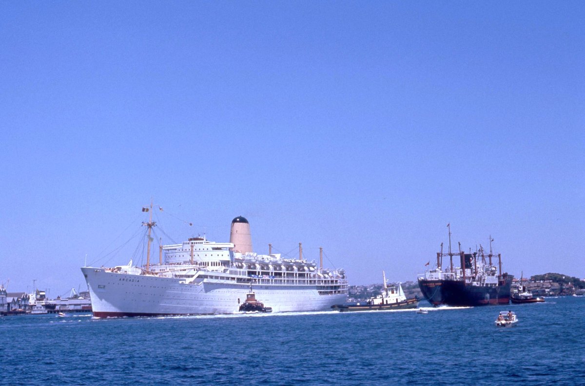 P & O Liner Arcadia passing Halsbury Shipping Ltd cargo ship New Guinea Chief just west of Harbour Bridge Sydney (1975)