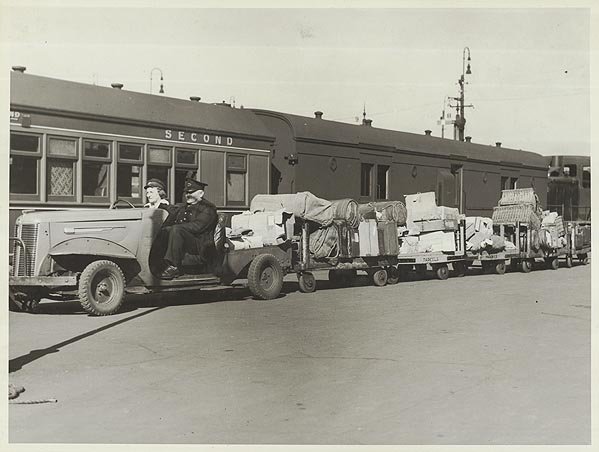 An Austin parcels tractor transporting luggage at Central Railway Station, Sydney (NSW), Haymarket (c. 1946)