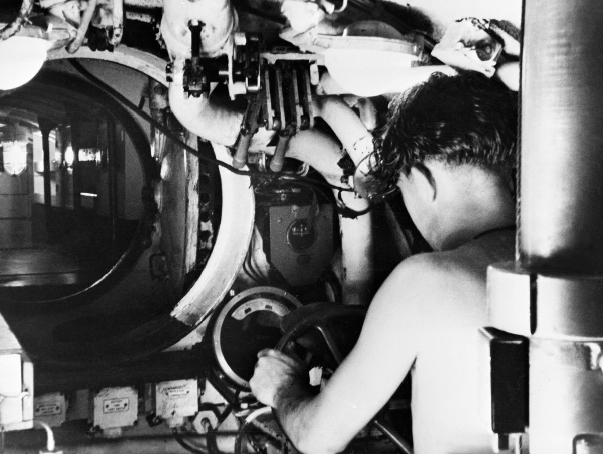 A submariner at the controls of a Royal Navy midget submarine in Sydney, Australia, 1945. A30570