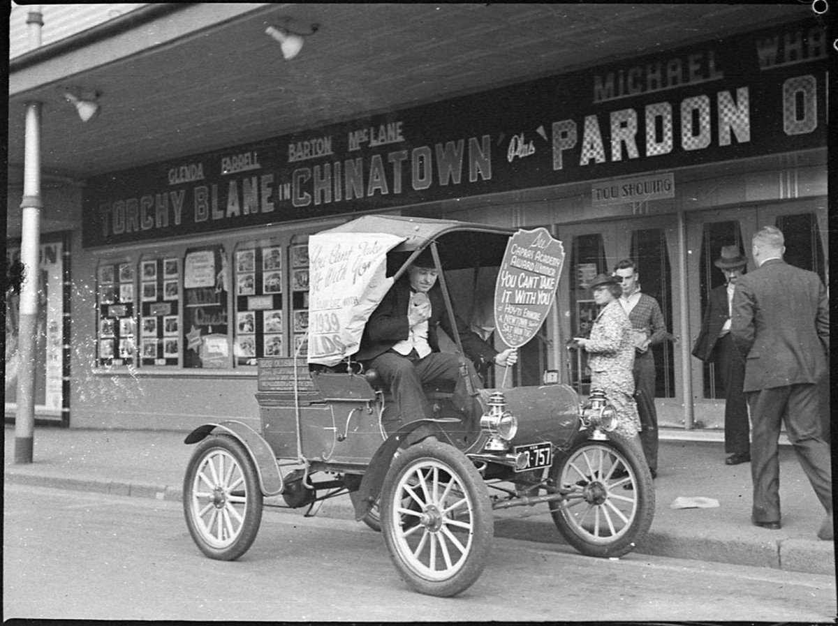 1902 curved dash Oldsmobile reg no AR757 Enmore Theatre advertising the film You cant take it with you and the 1939 Oldsmobile