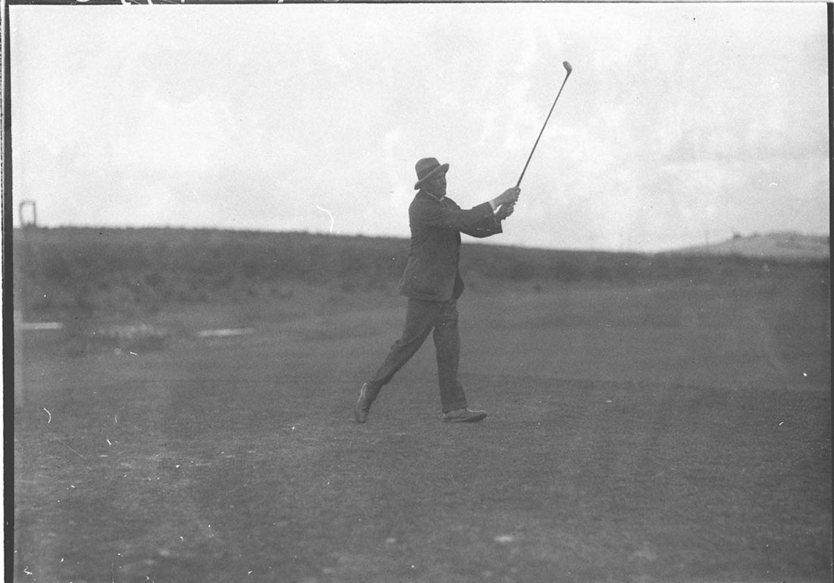 A golfer teeing off (1930s)