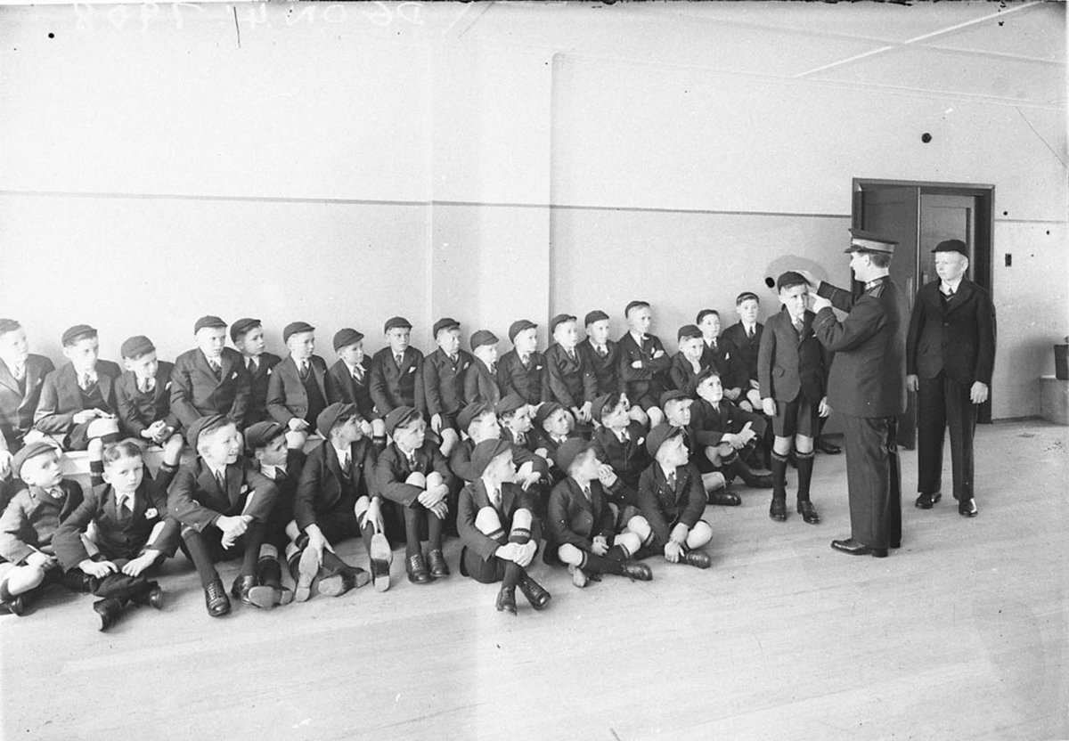 A Salvation Army officer lecturing a crowd of schoolboys (1930s)