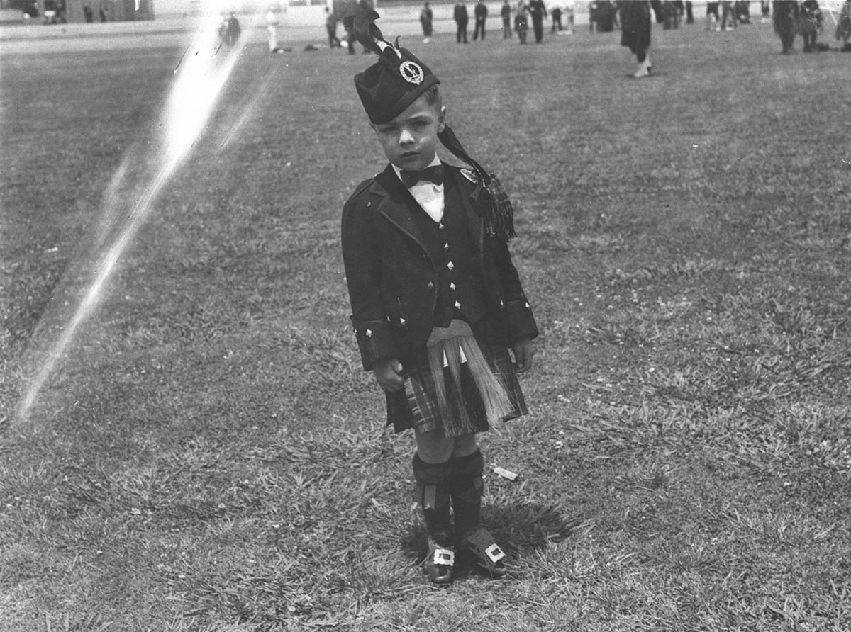 A wee lad in full Highland outfit at the Highland Societys Caledonian Games, Moore Park (1935)