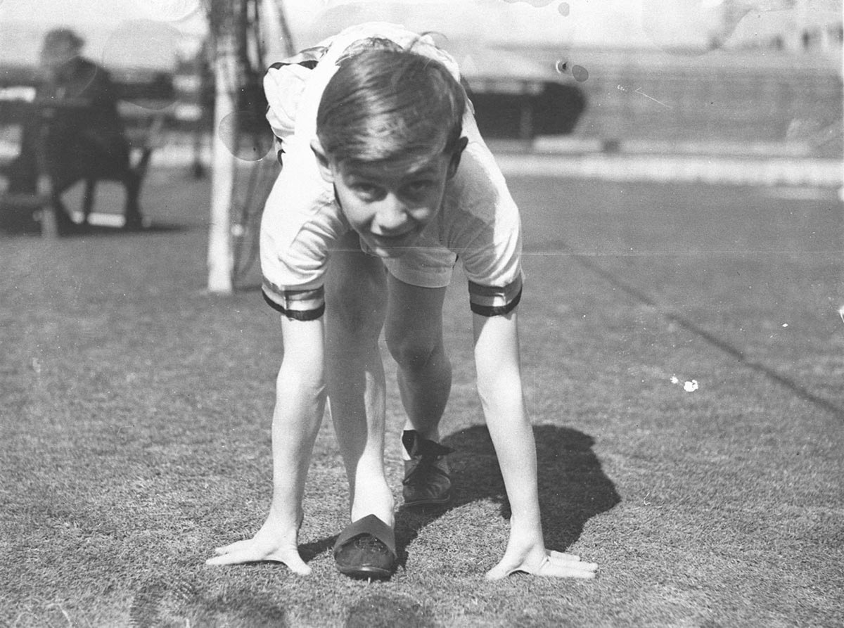 An under 12 sprinter on the starting blocks (c. 1929)