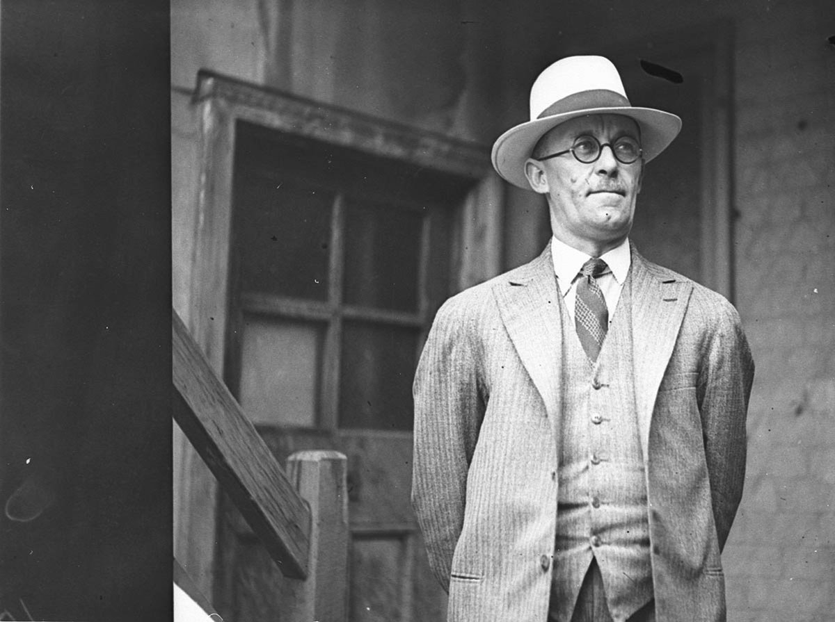 An unidentified man wearing hat and spectacles (c. 1929)