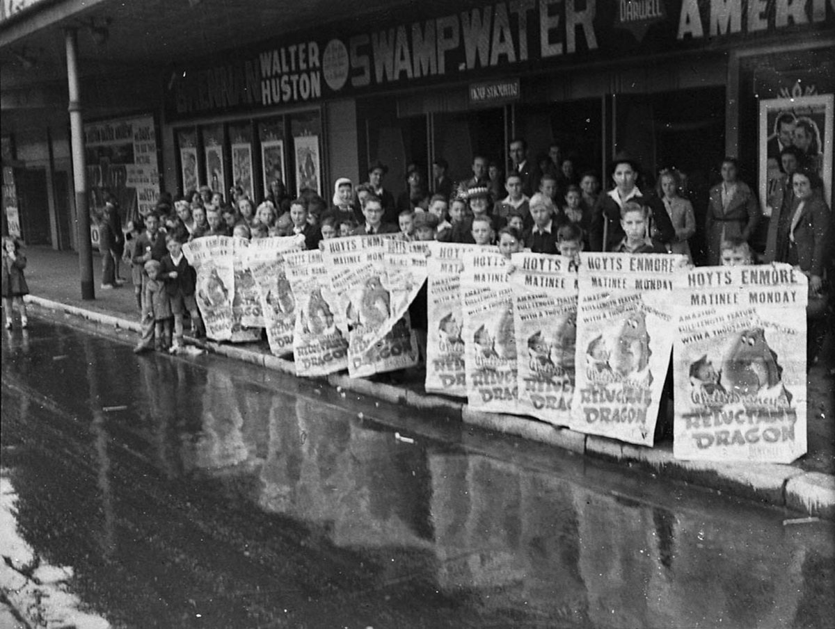 Children hold posters advertising Walt Disneys Reluctant dragon Enmore Theatre (1942)