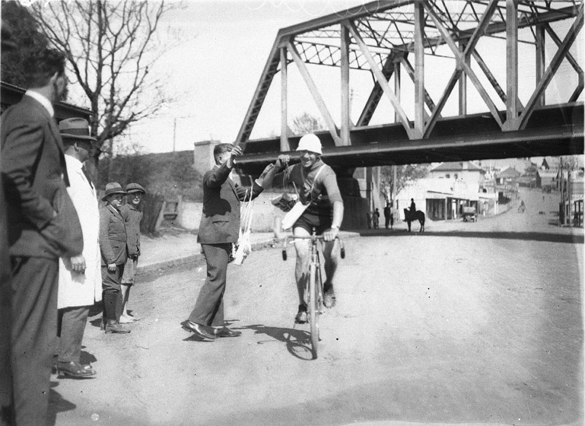 Competitor Madden receives a bottle of food (1930s)