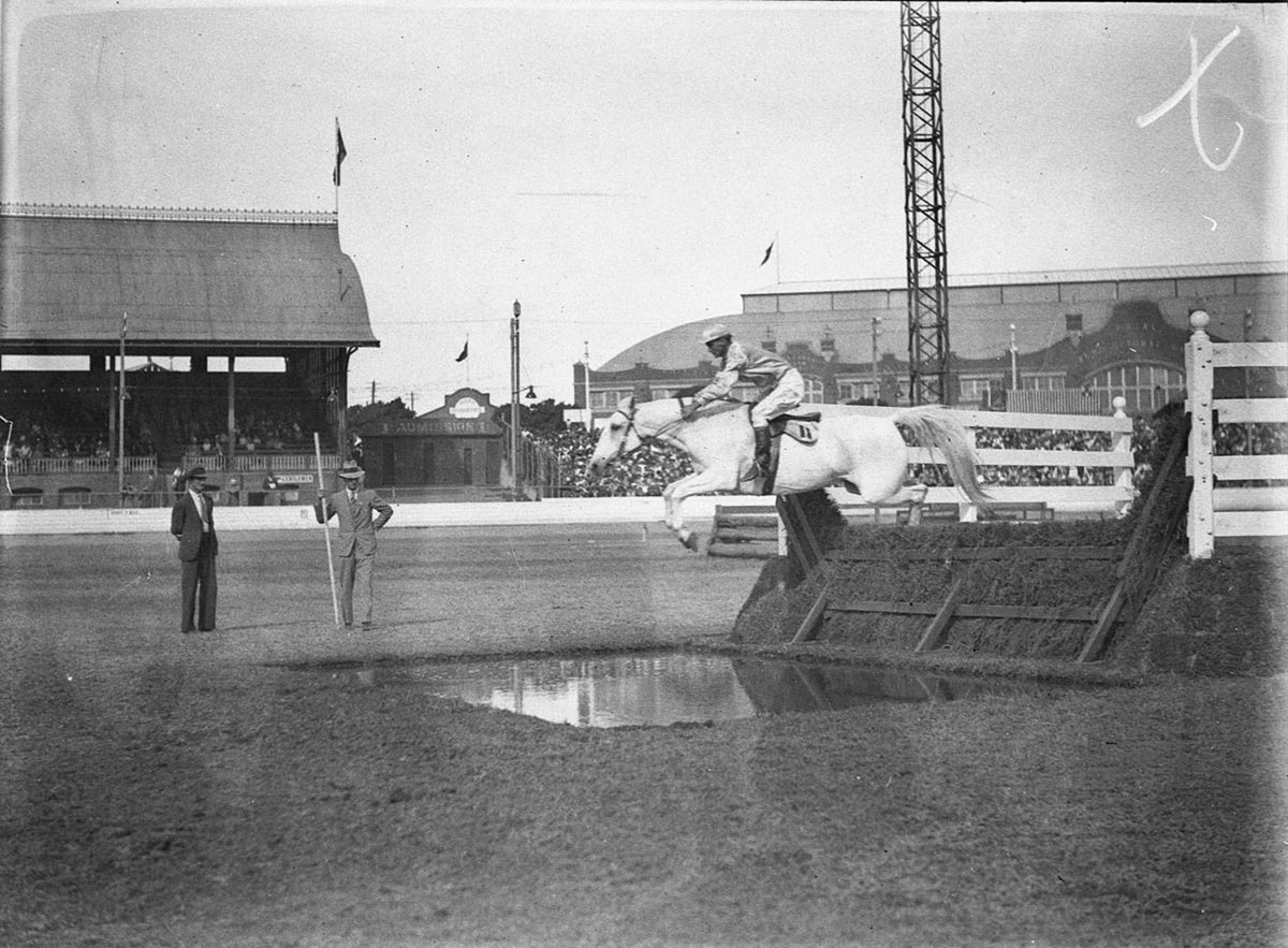 Competitor No 11 clears the brush hurdle and the water hazard (1925–57)