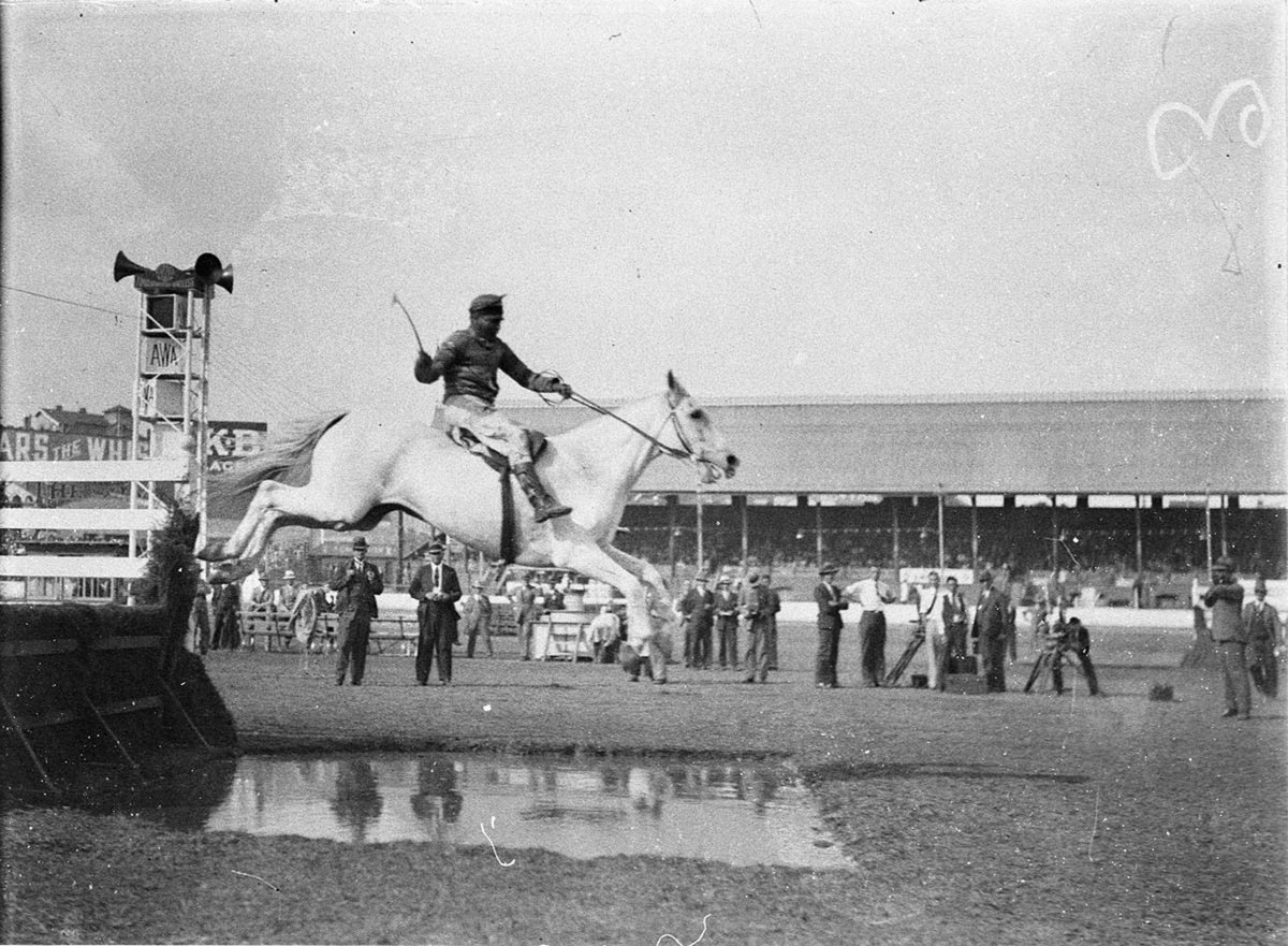 Competitor No 2 about to make a splash at the waterjump (1925–57)