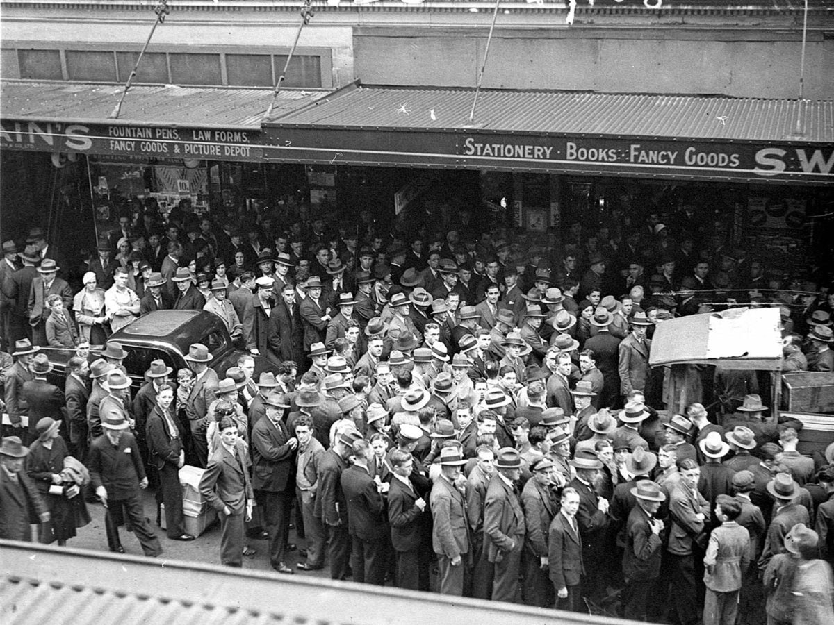 Crowd listening to the Melbourne Cup broadcast outside Swains Bookstore in Pitt Street Sydney, Sydney city centre (1934)
