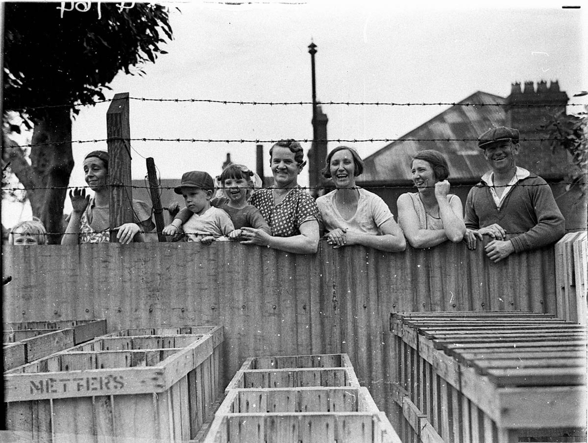 Crowds watch from over the fence (c. 1934)