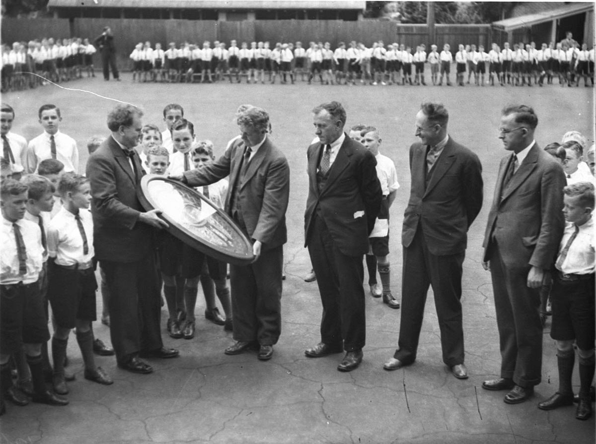 Director of Education G Ross Thomas presents the Drill Challenge Shield to Drummoyne Primary School (1934)