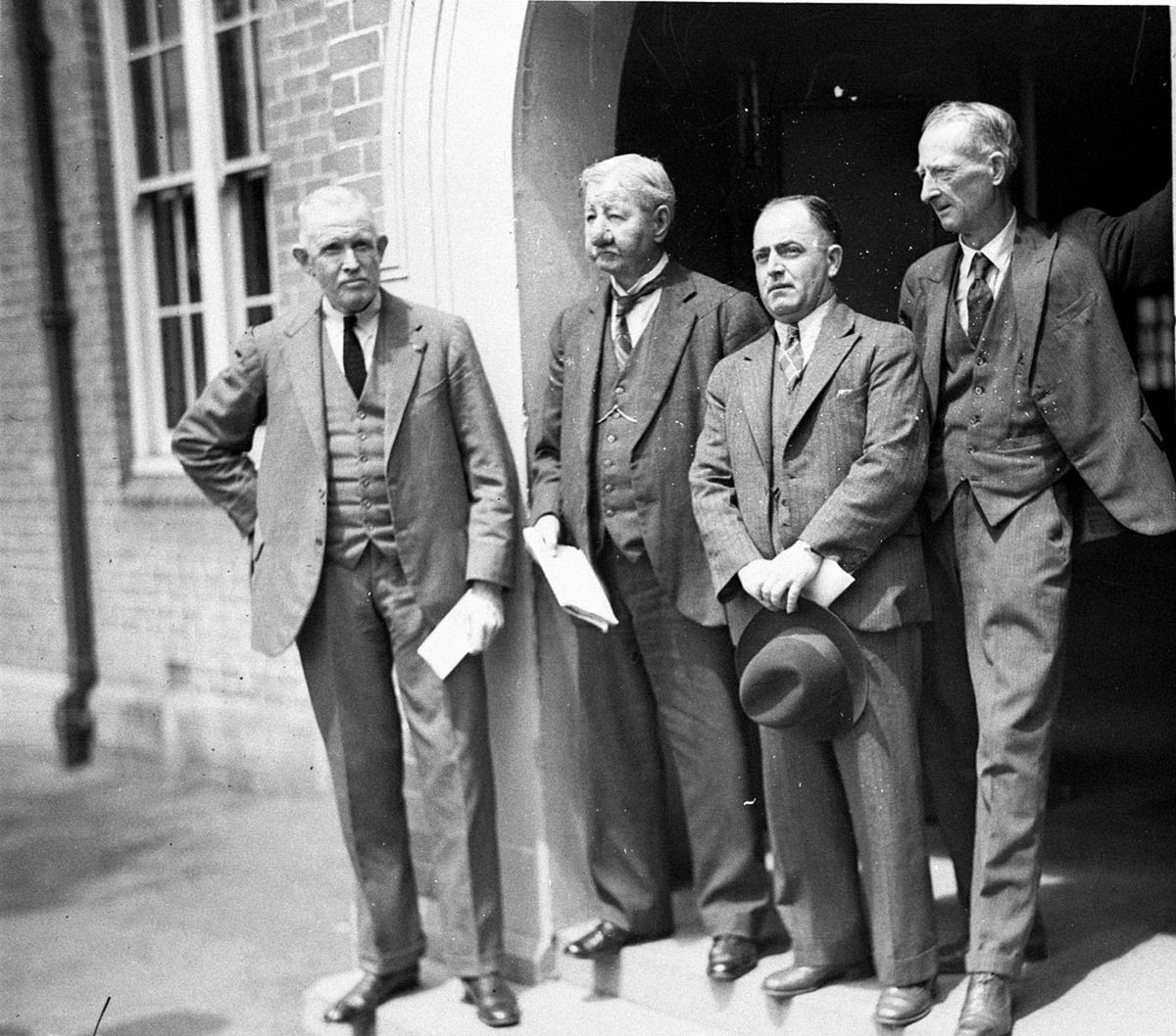 Electoral officer reading Declaration of the Polls with the three candidates (c. 1934)