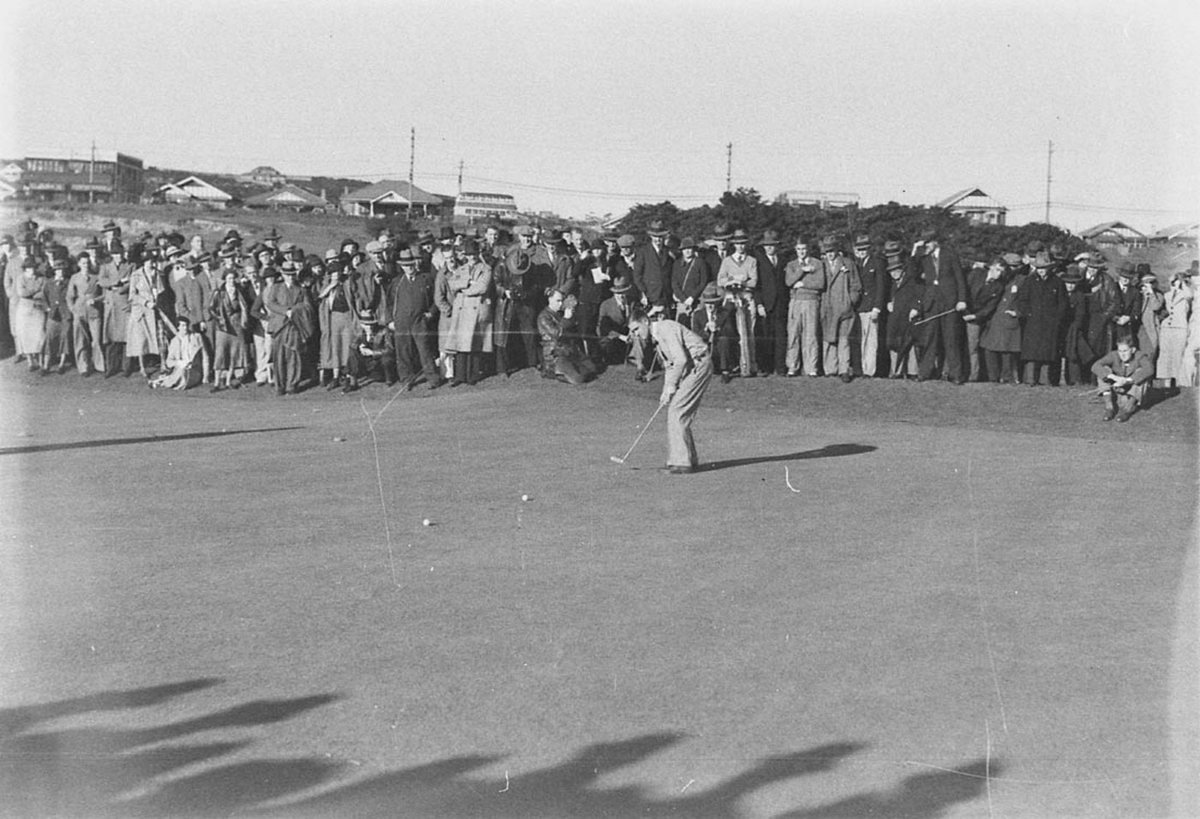Eric Cremin putting Newsreel cameraman kneeling down and Sun photographer Baden Mullaney near (1930s)