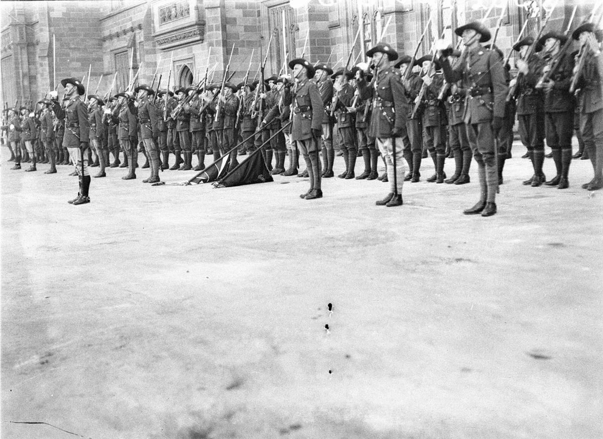Flag bearers colour party and guards present arms (c. 1931)