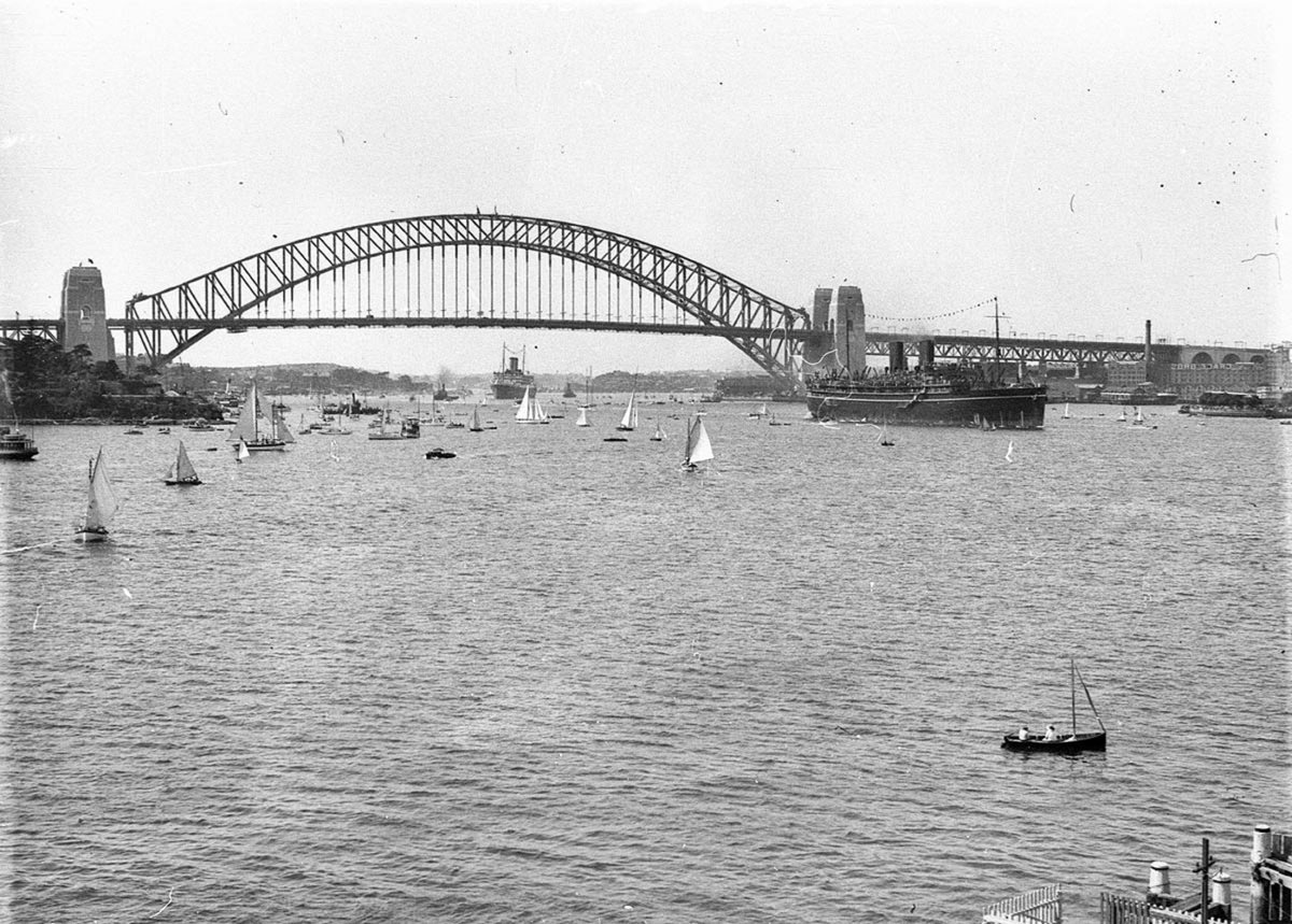 Flotilla of ships and small craft pass under the Bridge, 1932