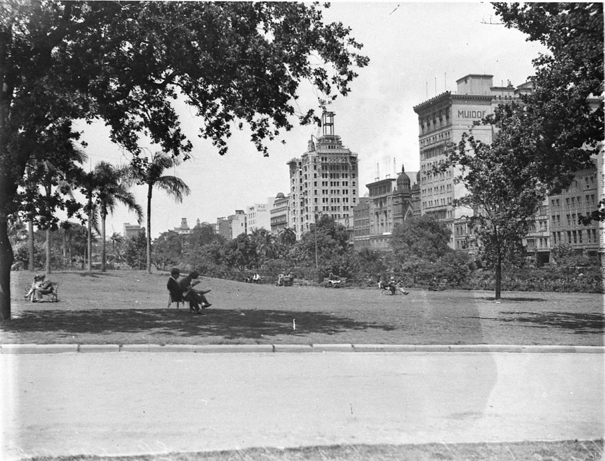 Ground level view of Hyde Park showing uncompleted T G Building the Synagogue and the Manchester Unity Building, Sydney city centre (1930s)