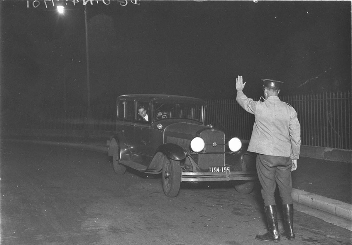 Illustrating a Police Safety Campaign showing a traffic policeman stopping Ted Hood driving his fathers 1927 Studebaker Commander sedan