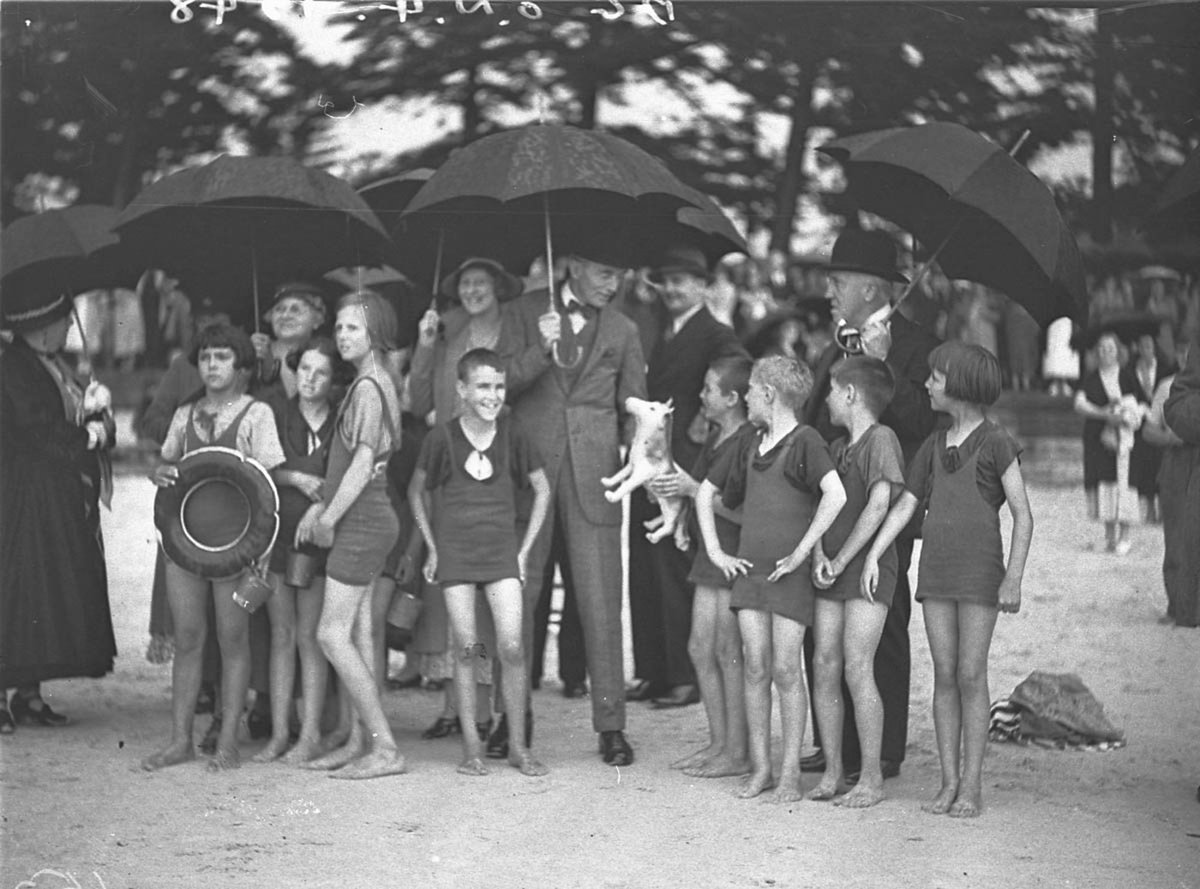 Kids in their bathers in heavy rain talking with the Governor (1930s)