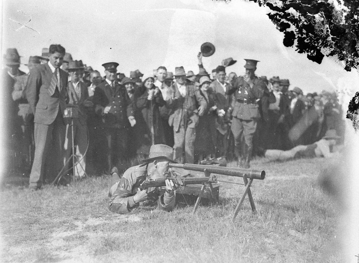Kings competitor in the final looks through his telescope to check score as onlookers cheer (1930)