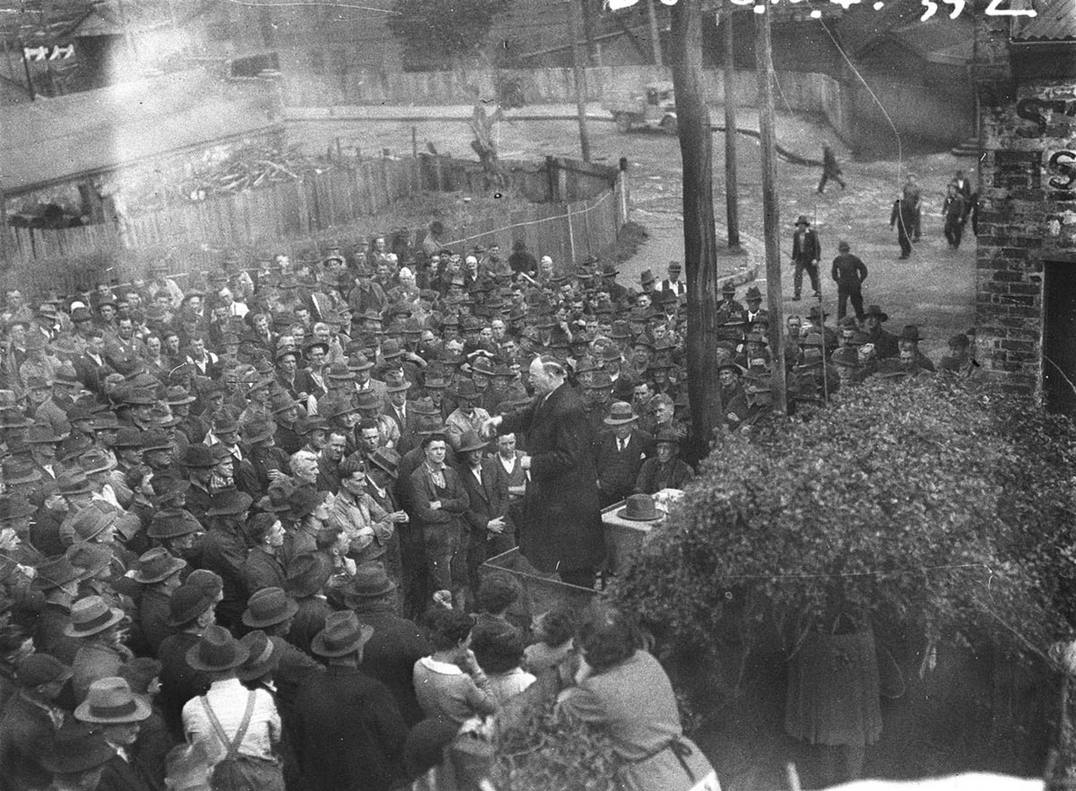 Mass rally of Eveleigh railway workers listens to an election speech from Jack Lang (1934)
