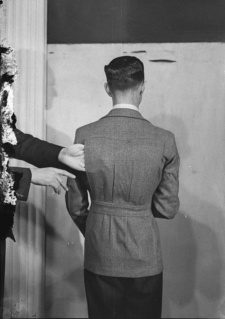 Model in coat with belt at the back (1939)