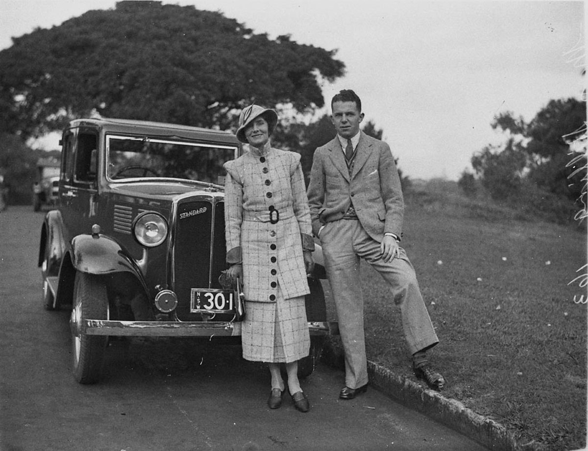 Mrs Stilling unidentified man beside her Standard car (1930s)