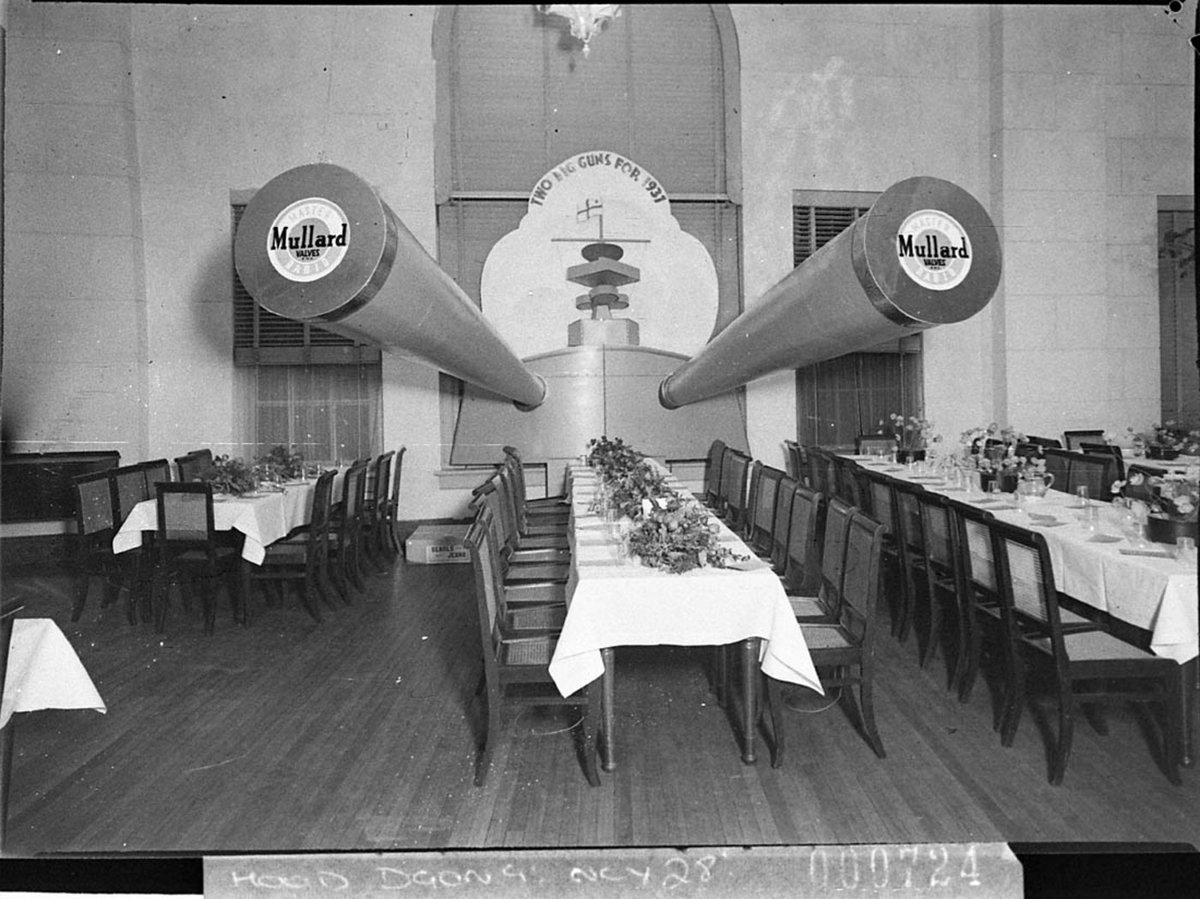 Mullard Radio Valves tableau at the Radio Ball two cannons as on a battleship project over their table (1937)