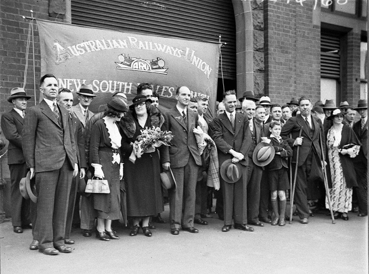 Officials and members stand in front of their banner (c. 1934)