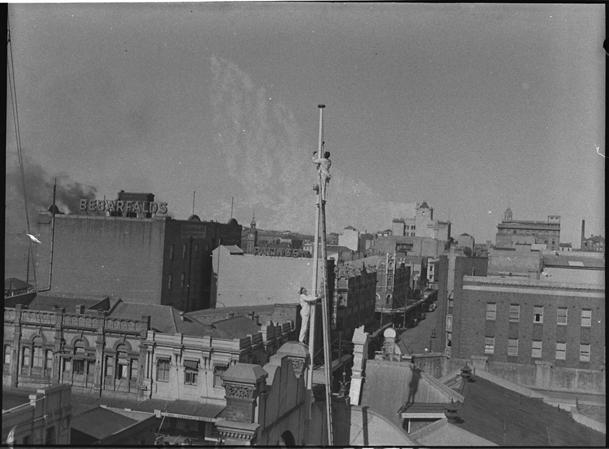 Painting flag poles at Scotts Store Hunter Street Newcastle, Sydney city centre (1955)