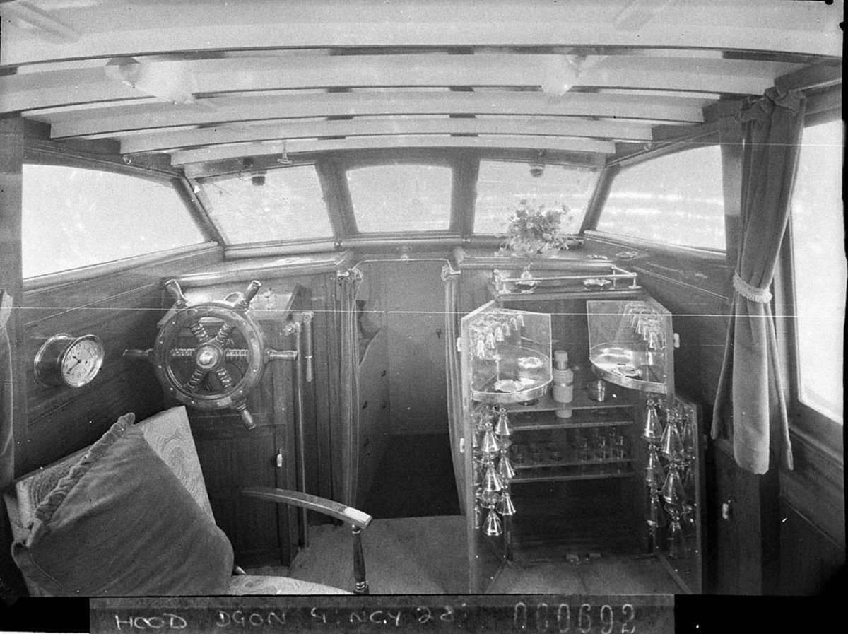 Part of lounge and wheelhouse with ships wheel and bar on the cabin cruiser Leisurlea (1937)