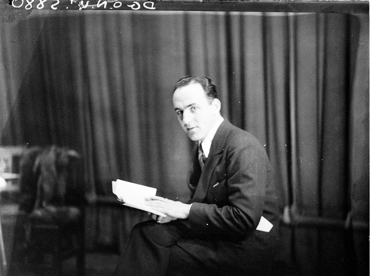 Portrait of man reading a script, by Sam Hood (1930s)