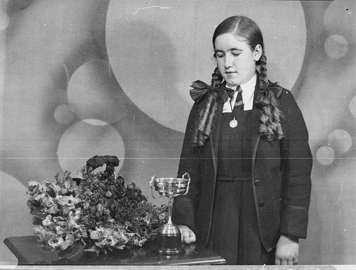 Pupil of St Marys Commercial College with trophies, Sydney city centre (1937)