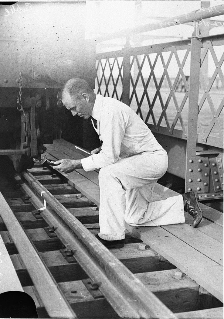 Railway engineer taking measurements of surfaces of track, Sydney Harbour (1930–32)