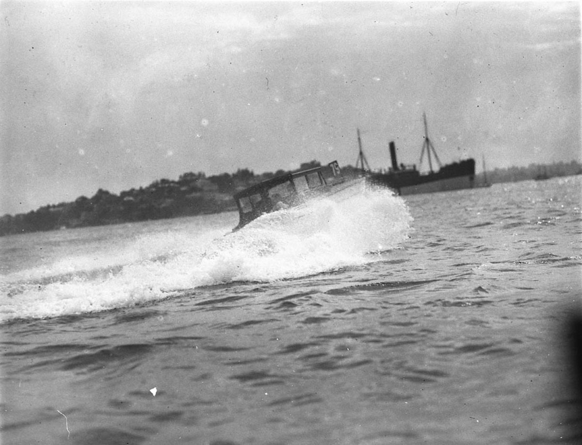 Speedboat 79 almost invisible through a cloud of spray (1930s)