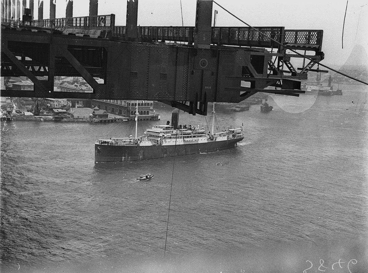 SS Liverpool passes underneath the decking girders and hangers, Sydney Harbour (c. 1930)