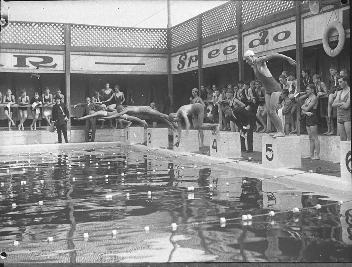 Start of a relay race showing five swimmers diving in Colleges swimming at Drummoyne (1935)