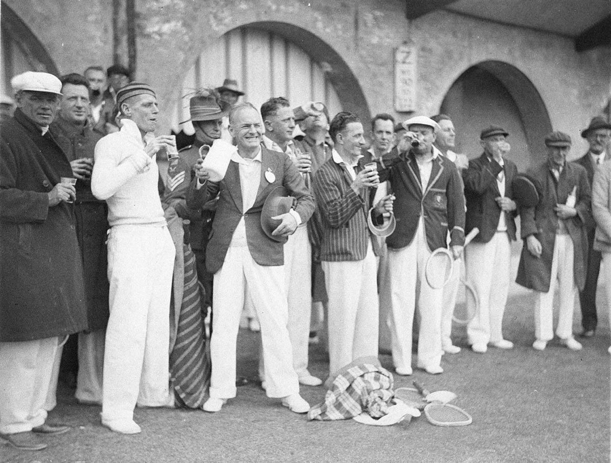 Tennis players drink a toast as Army bugler plays at AIF tennis day (1930s)