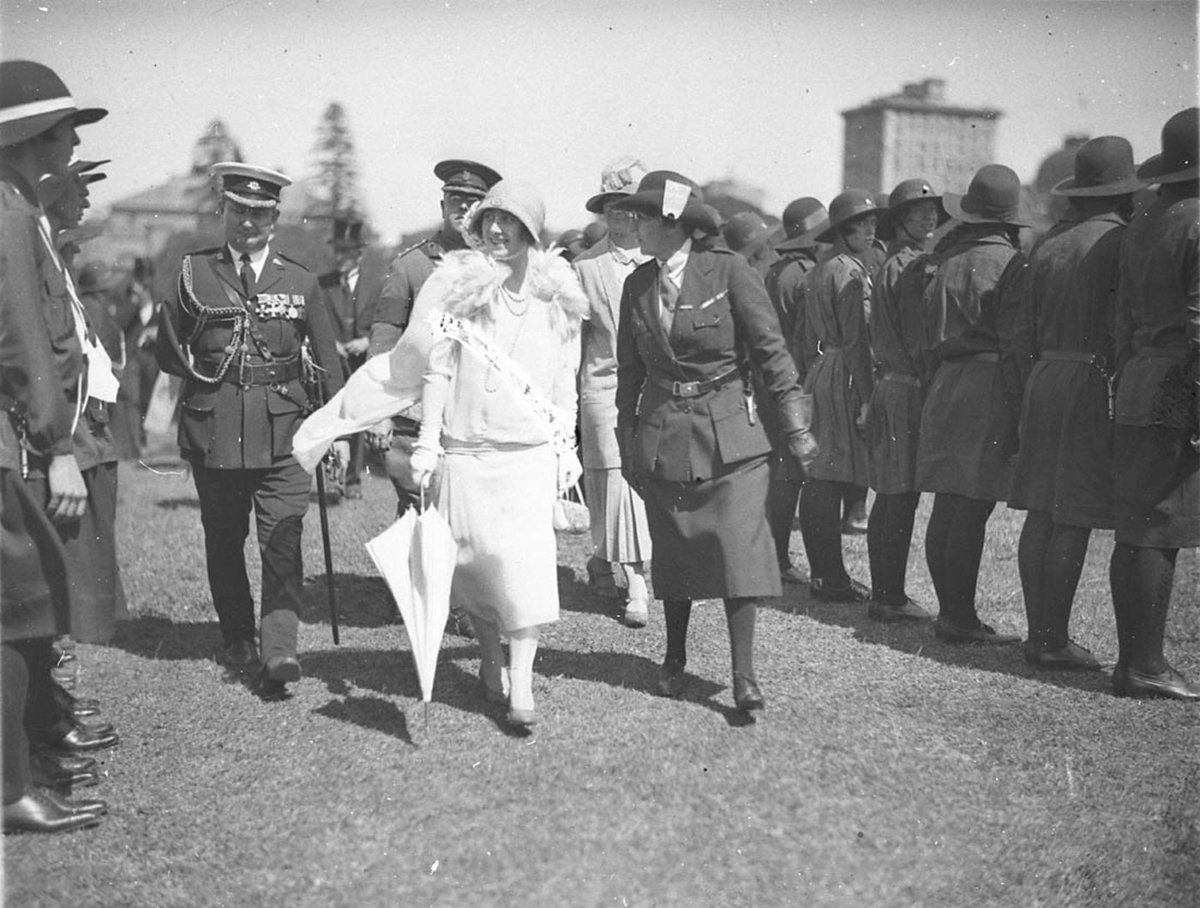 The Duchess walking with chief of the Girl Guides (1927)