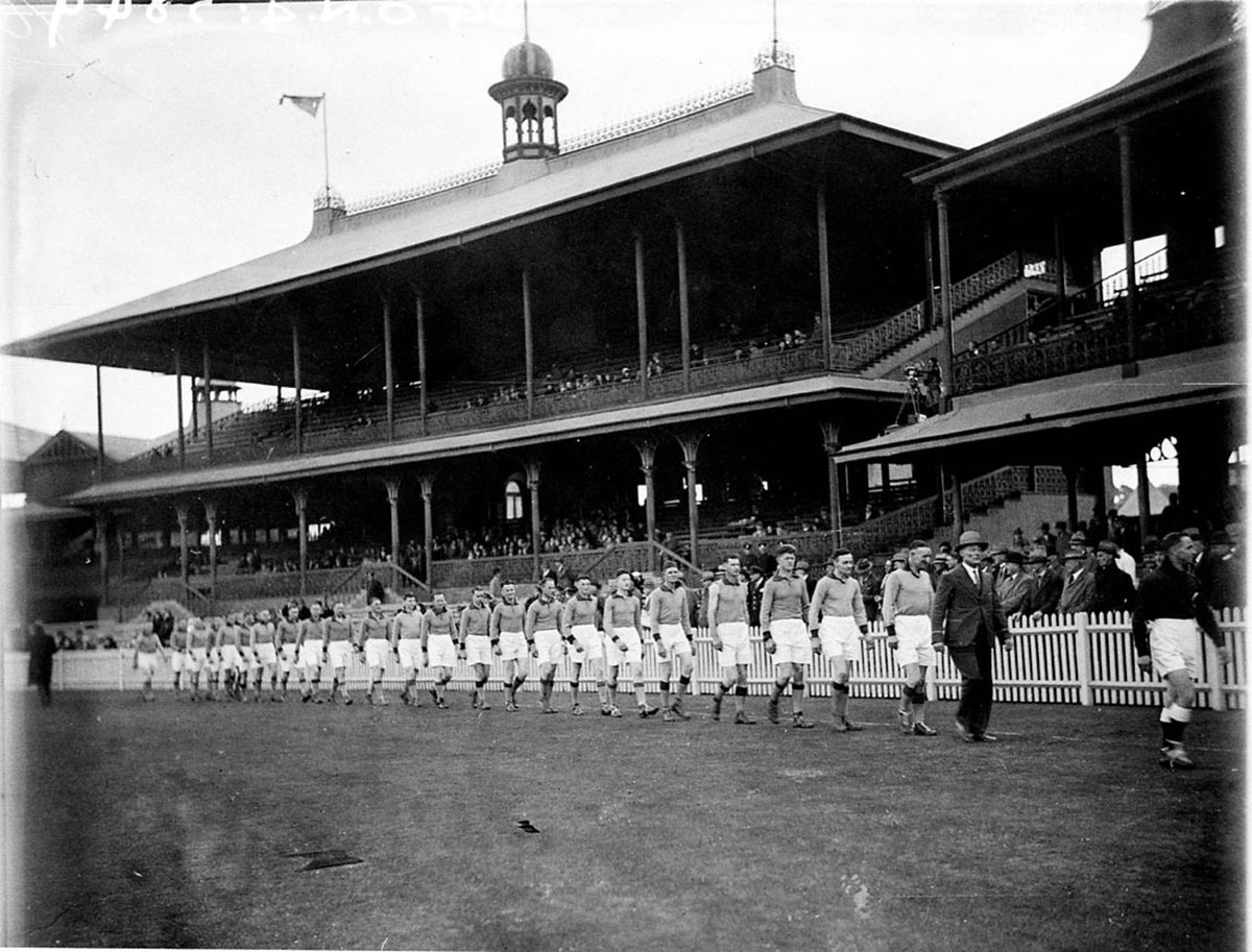 The last player from the Queensland team is followed by the Canberra team marching on in the opening ceremony on the AllStates Australian Football Carnival at the SCG 5 August 1933, Moore Park