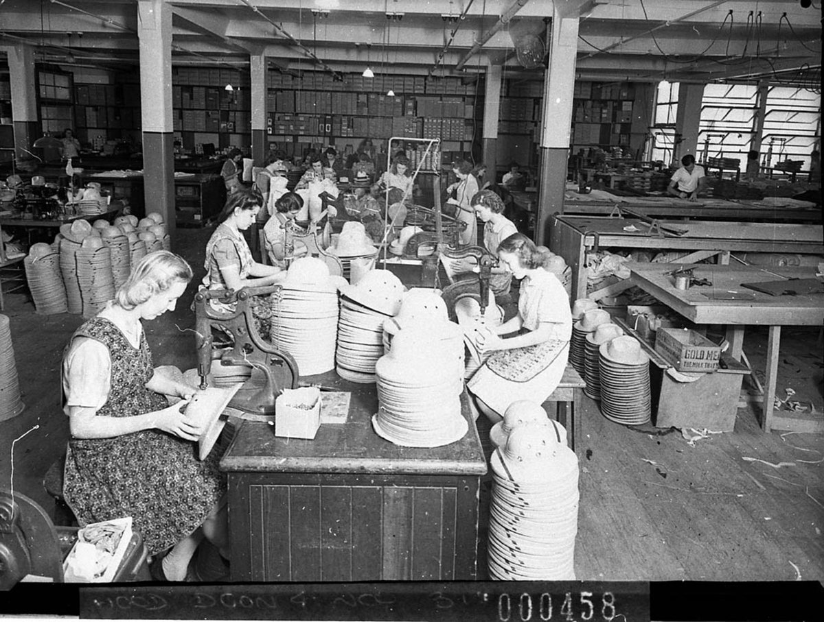 Top Dog factory for mens hats showing female workers machining the braid (1941)