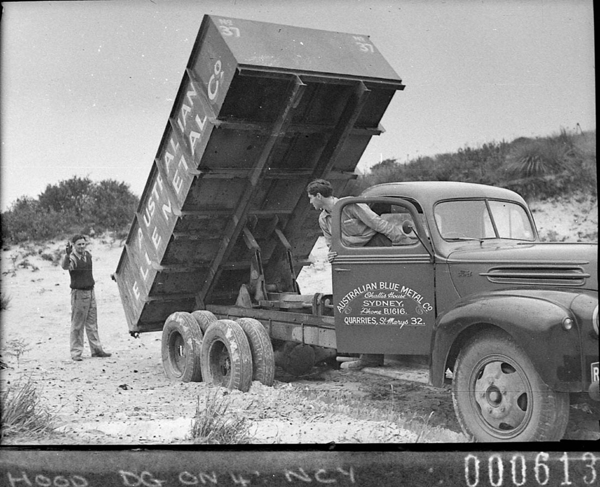 Truck tipping its load Australian Blue Metal Co trucks for Mr Freeman Ford News, Sydney (1944)