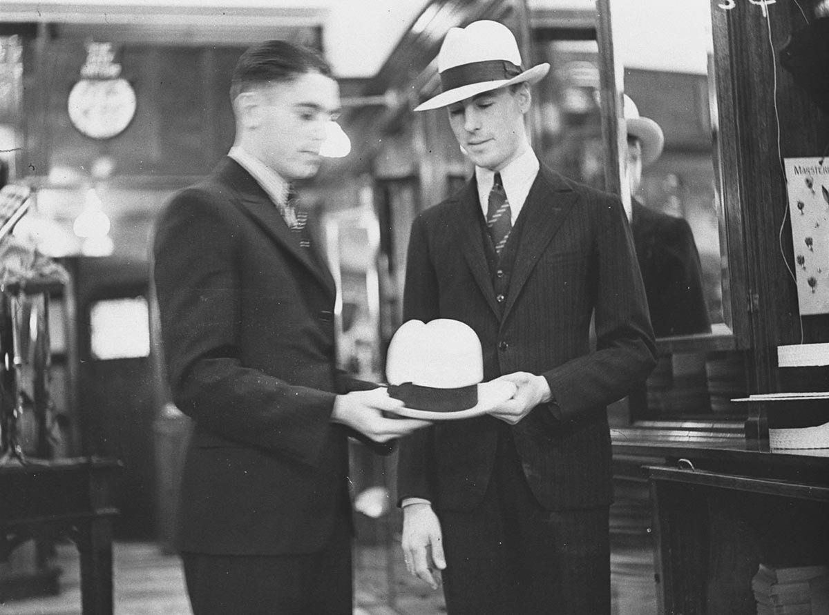 Two men modelling hats in City Hatters Pitt Street, Sydney city centre (1934)