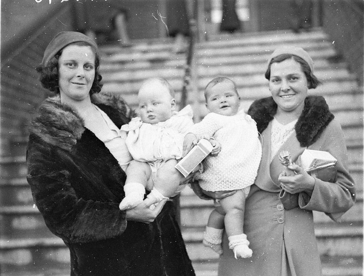 Two mothers holding their babies (1930s)