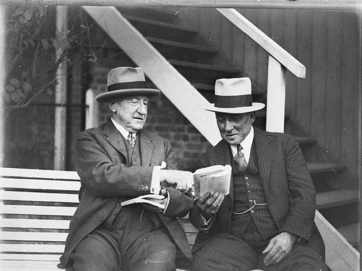 Two unidentified cattlemen studying their catalogue (1925–57)