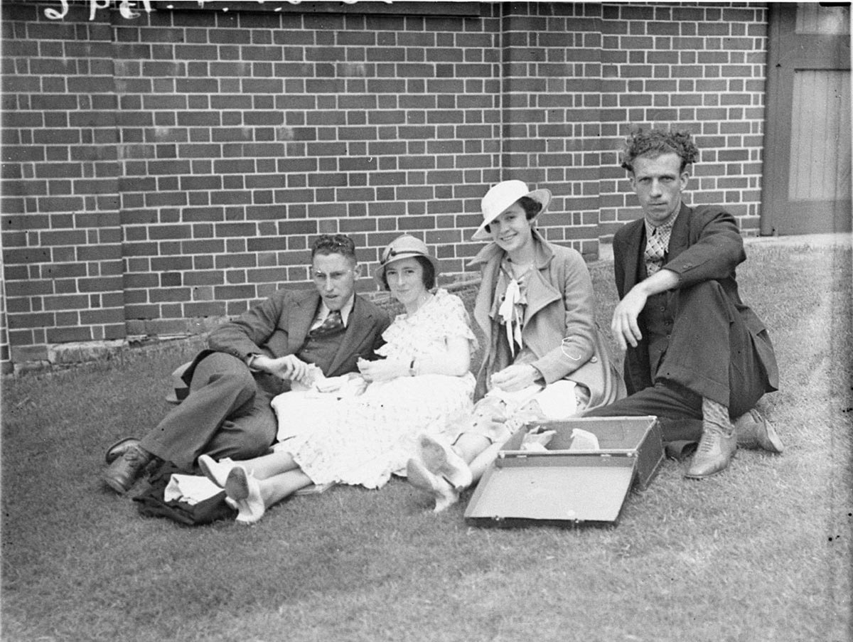Two unidentified couples sitting on the grass at the NSWVictoria 2nd XI cricket (1934)