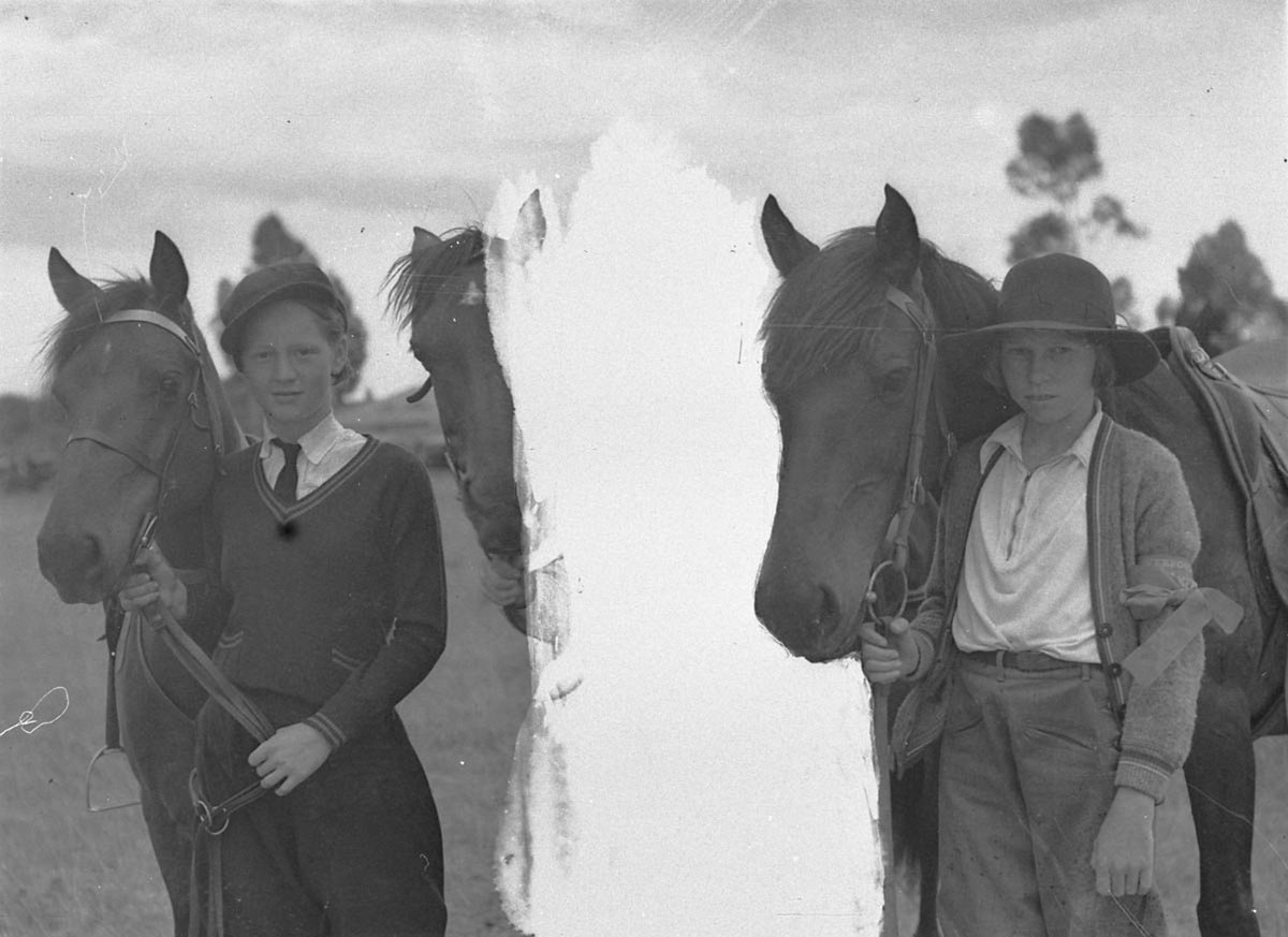 Two young women riders with their horses (c. 1932)