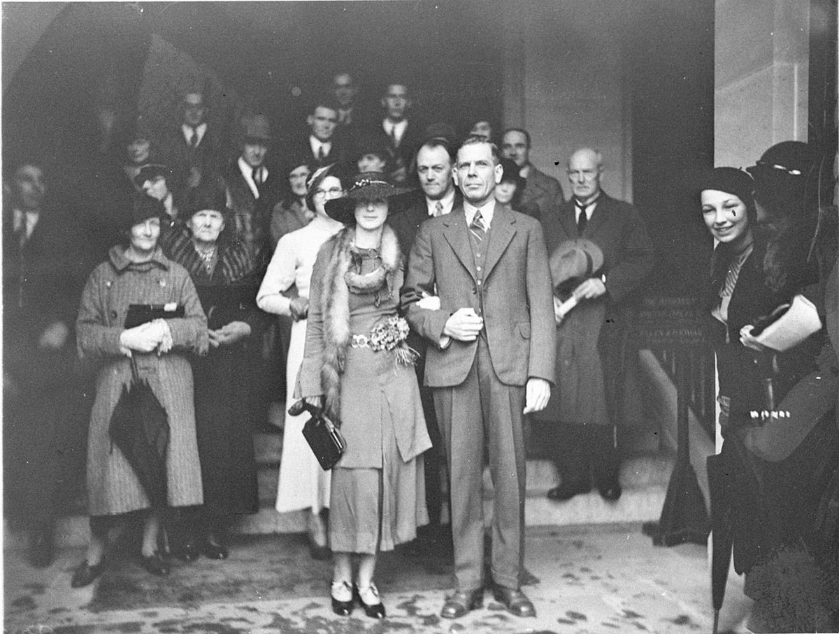 Unidentified bridal couple on steps of Registry Office (1930s)