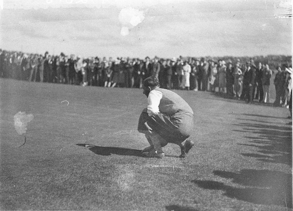 Unidentified golfer lines up a putt (1934)